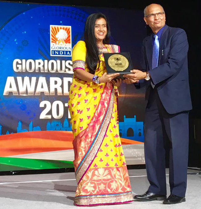Dr. Joshi accepting an award at the Glorious India Expo in New Jersey in 2018.